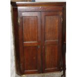 An 18thC oak mahogany and inlaid hanging corner cupboard, the panelled doors hinging to reveal a