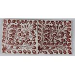 Two William De Morgan tiles, decorated with pink lustre leaves on a white ground, Stamp End period
