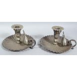 A pair of 19thC Old Sheffield plate chamber sticks, each with floral dished bases, centred by