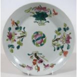 A Chinese Kangxi style porcelain dish, of circular outline, centred with flower heads with an