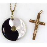 Two items of jewellery, to include a Chinese pendant and chain and a crucifix, the pendant in the