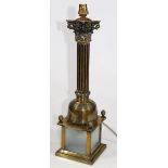 A modern brass table lamp, with Corinthian column stem, square base, frosted glass door and modern