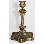 A George II style gilt metal candlestick, probably early 20thC with inverted floral stem, stylised