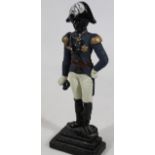 A cast iron door stop, formed as a Napoleonic soldier on stepped base, partially decorated, 41cm