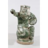 A Song style pottery Chinese figure, of a gentleman partially green glazed, (hollow), 24cm high (