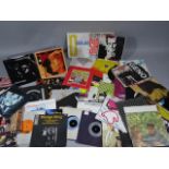 Various 45's records, David Bowie, Duran Duran , The Eurythmics, etc. and a CD rack. (a quantity)
