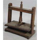 A late 19thC mahogany book press, of shaped outline with articulated turned centre and screw top, (