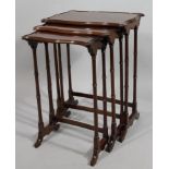 A nest of three Edwardian mahogany tables, each serpentine top raised on bamboo style cylindrical