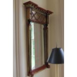 A reproduction Regency pier glass, with Egyptian columns, 46cm wide, 95cm high.
