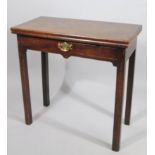 An early 19thC mahogany fold over tea table, with central draw with brass plate back on square