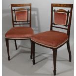 A pair of Edwardian mahogany and boxwood strung hall chairs, each with curved overstuffed backs
