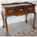 A 20thC style walnut silver table, with galleried top, the rectangular body raised by acanthus