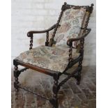 A late 19thC oak adjustable Carolean style chair, the carved top rail raised above barley twist