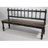 An early 19thC oak bench, with barleytwist and block backs surmounted by compressed finials above