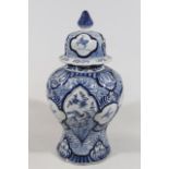 A Dutch Delft blue and white jar and cover, decorated with panels of animals and flowers, the