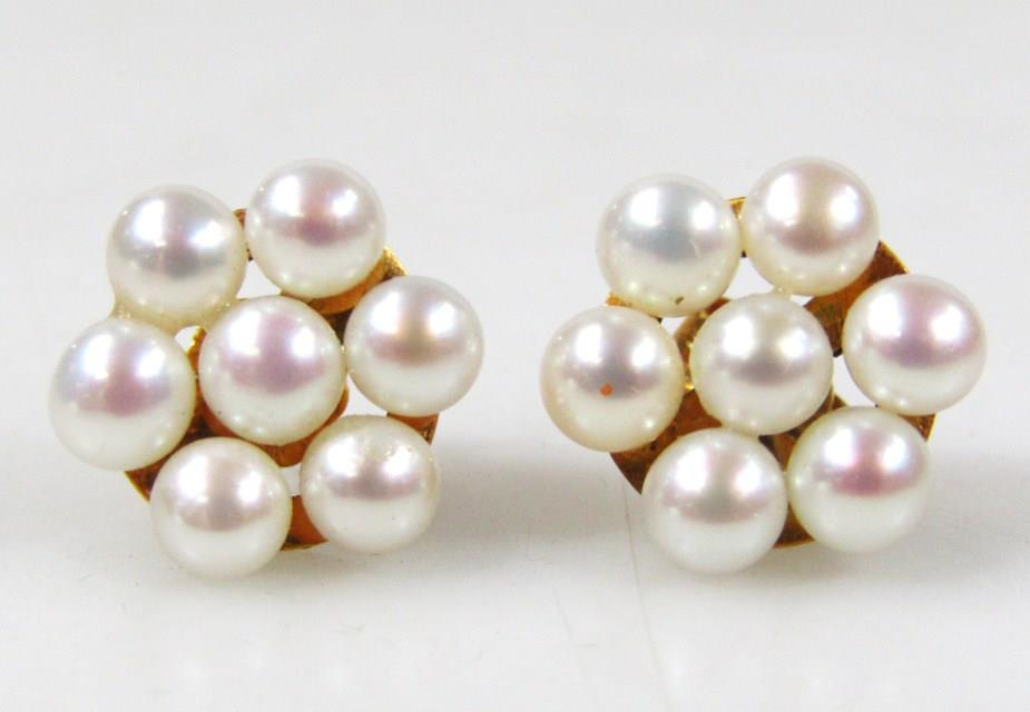 A pair of floral cultured pearl earrings, set with 7 cultured pearls, a yellow metal frame with