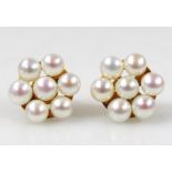 A pair of floral cultured pearl earrings, set with 7 cultured pearls, a yellow metal frame with