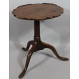 A late 18thC oak occasional table, with pie crust top on gun barrel support terminating in triple