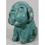 An early to mid 20thC green glazed Sylvac style pottery dog, seated with tongue out, impressed marks