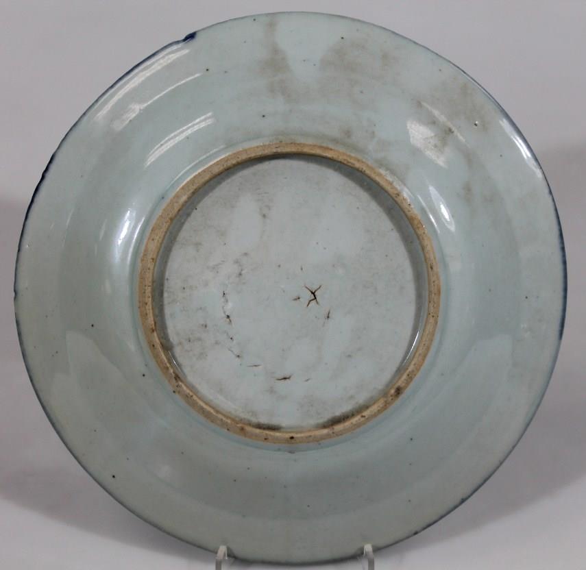 An 18thC Chinese blue and white porcelain plate, the centre heavily decorated with pagoda boats - Image 2 of 2