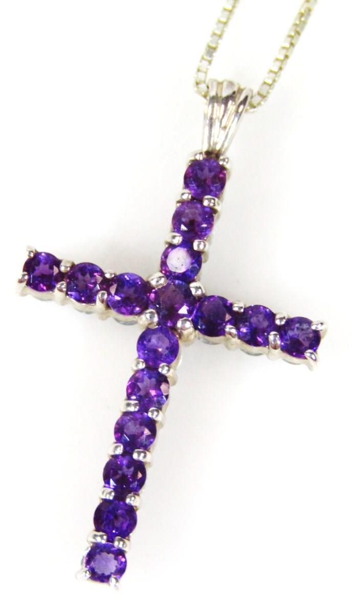 A silver stone set crucifix pendant, on a box link silver chain, a crucifix set with purple