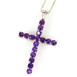 A silver stone set crucifix pendant, on a box link silver chain, a crucifix set with purple