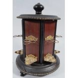 An early 20thC polished mahogany and ebonised cigar stand, with polished knop, articulated doors and