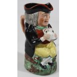 A mid 19thC cross legged Toby jug, in the manner of William Kent, holding a jug in both hands with