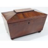 A mid 19thC mahogany sarcophagus shaped tea caddy, the lid hinging to reveal a plain interior (now a