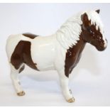 A Beswick Shetland pony, in brown and white colourway, with black Beswick stamp to hoof, and stamped