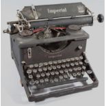 An early 20thC Imperial typewriter, the metal frame with circular articulated keys, 35cm wide.