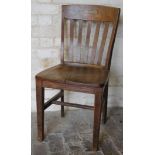 A mid 20thC oak office chair, with fixed back, vertical splats, shaped seat, square tapering