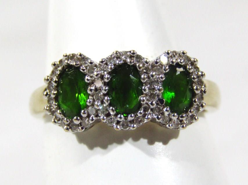 A 9ct gold dress ring, set with green and white stones, in the Art Deco style, 3g all in.