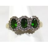 A 9ct gold dress ring, set with green and white stones, in the Art Deco style, 3g all in.