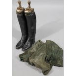 A pair of 20thC black leather riding boots, size unknown, 51cm high, with wooden lasts.
