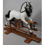 A 20thC Paul Bakker Victorian style rocking horse, with leather finish stirrup and black mane, on