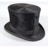 A mid 20thC top hat, in black, with velvet trim, 14cm high, interior measurements 20cm x 16cm. (