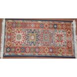 A 20thC Turkish rug, of repeat geometric pattern, with a diamond shaped centre predominantly in