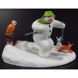 A Coalport Characters The Snowman figure group, Off Piste, printed marks beneath, 12cm high.
