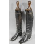A pair of mid 20thC leather riding boots, with wooden tree lasts, marked Maxwell, London, 62cm high,