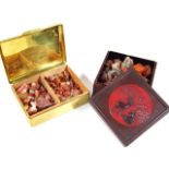Various loose stones to include three amber style beads, a fossil etc., contained in two boxes,