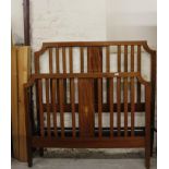 An Edwardian mahogany and boxwood strung double bed frame, with urn inlay, 140cm wide, with metal
