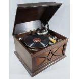 A mid 20thC HMV tabletop wind up gramophone, the oak case with domed lid, hinging to reveal an