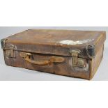 A mid 20thC pressed leather travel case, with shaped handle and metal mounts, 65cm wide.