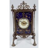 An early 20thC Aesthetic style metal clock surround, with a pierced scroll and urn top, urn