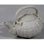 An early 20thC Belleek shell pattern teapot, with plain scroll handle, shaped spout and circular