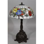 A modern table lamp, with frosted glass floral shade with lead style panelling, on a heavy metal