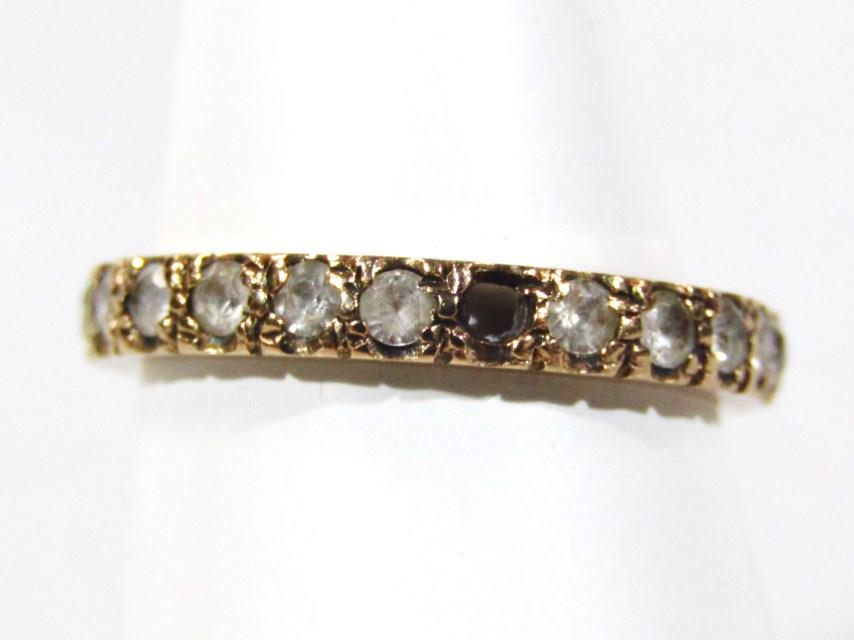 A 9ct gold eternity ring, set with white stones (AF one missing), 1.9g all in, boxed.