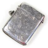 A George V silver vesta case, of oblong outline, engraved with a central initialled shield