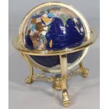 A modern table top terrestrial globe, with articulated centre on a metal stand terminating in a